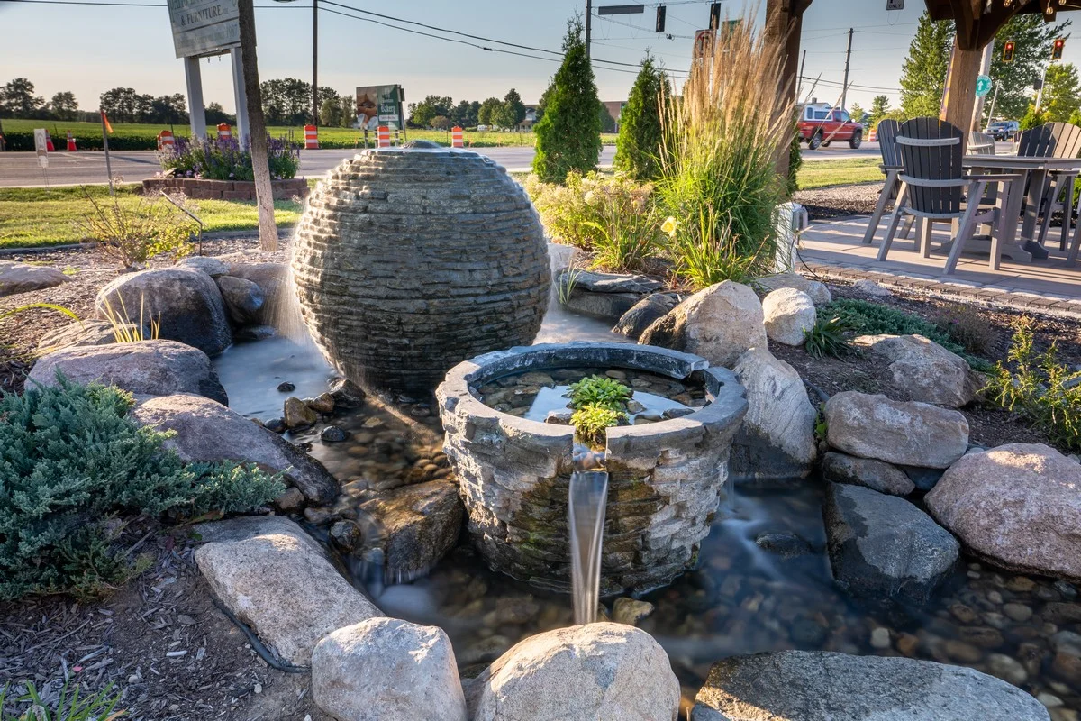 Stone water fountain with plants and rocks